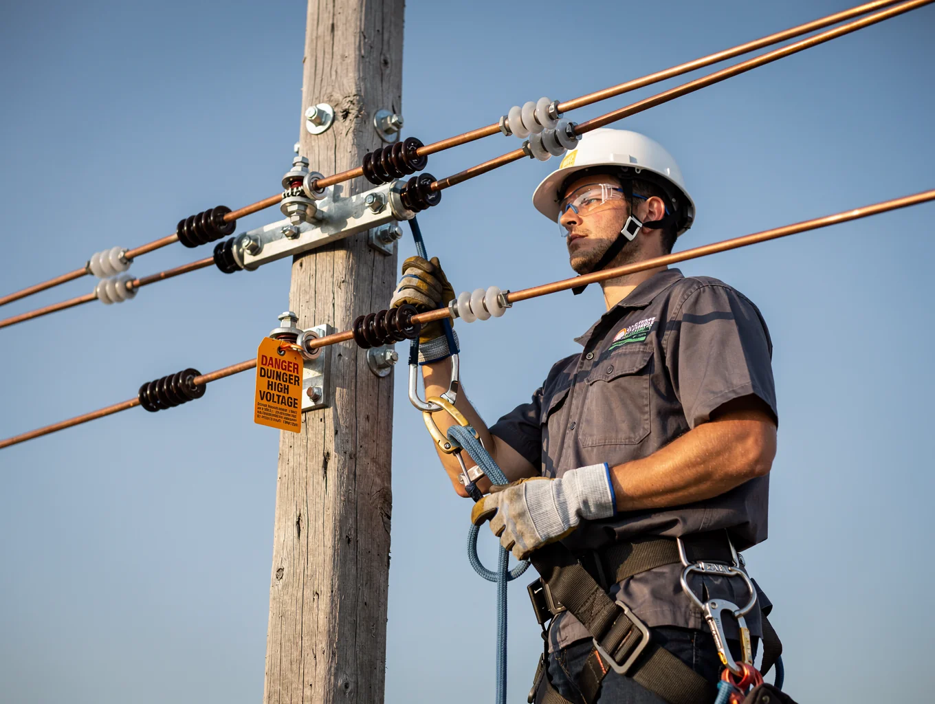 Accredited Level 2 electrician completing an overhead service line connection in Sydney